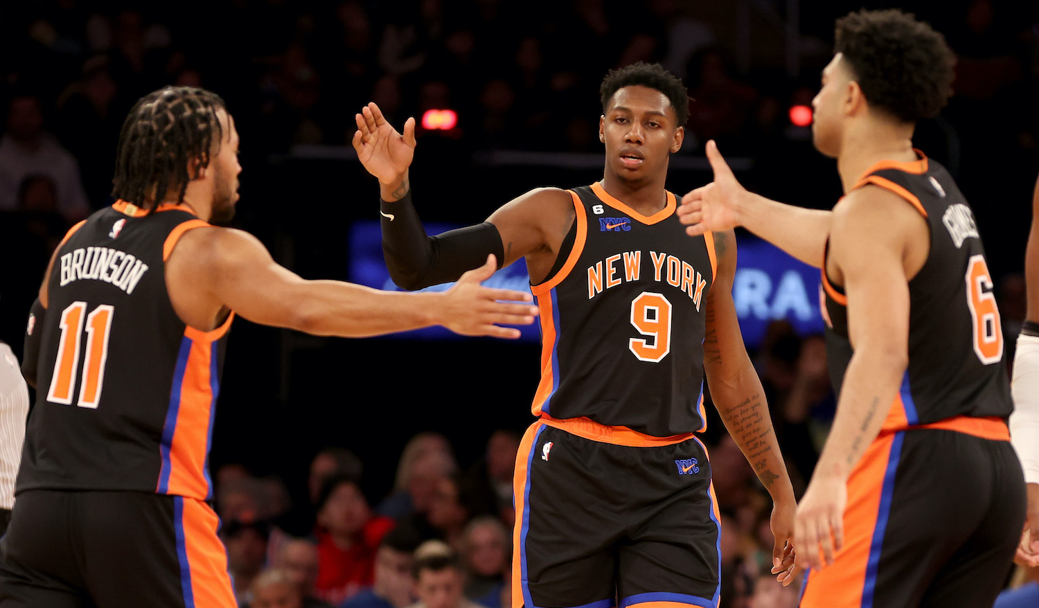 NEW YORK, NEW YORK - DECEMBER 20: Jalen Brunson #11, RJ Barrett #9 and Quentin Grimes #6 of the New York Knicks celebrate a basket against the Golden State Warriors during the second quarter of the game at Madison Square Garden on December 20, 2022 in New York City. NOTE TO USER: User expressly acknowledges and agrees that, by downloading and/or using this photograph, User is consenting to the terms and conditions of the Getty Images License Agreement. (Photo by Sarah Stier/Getty Images)
