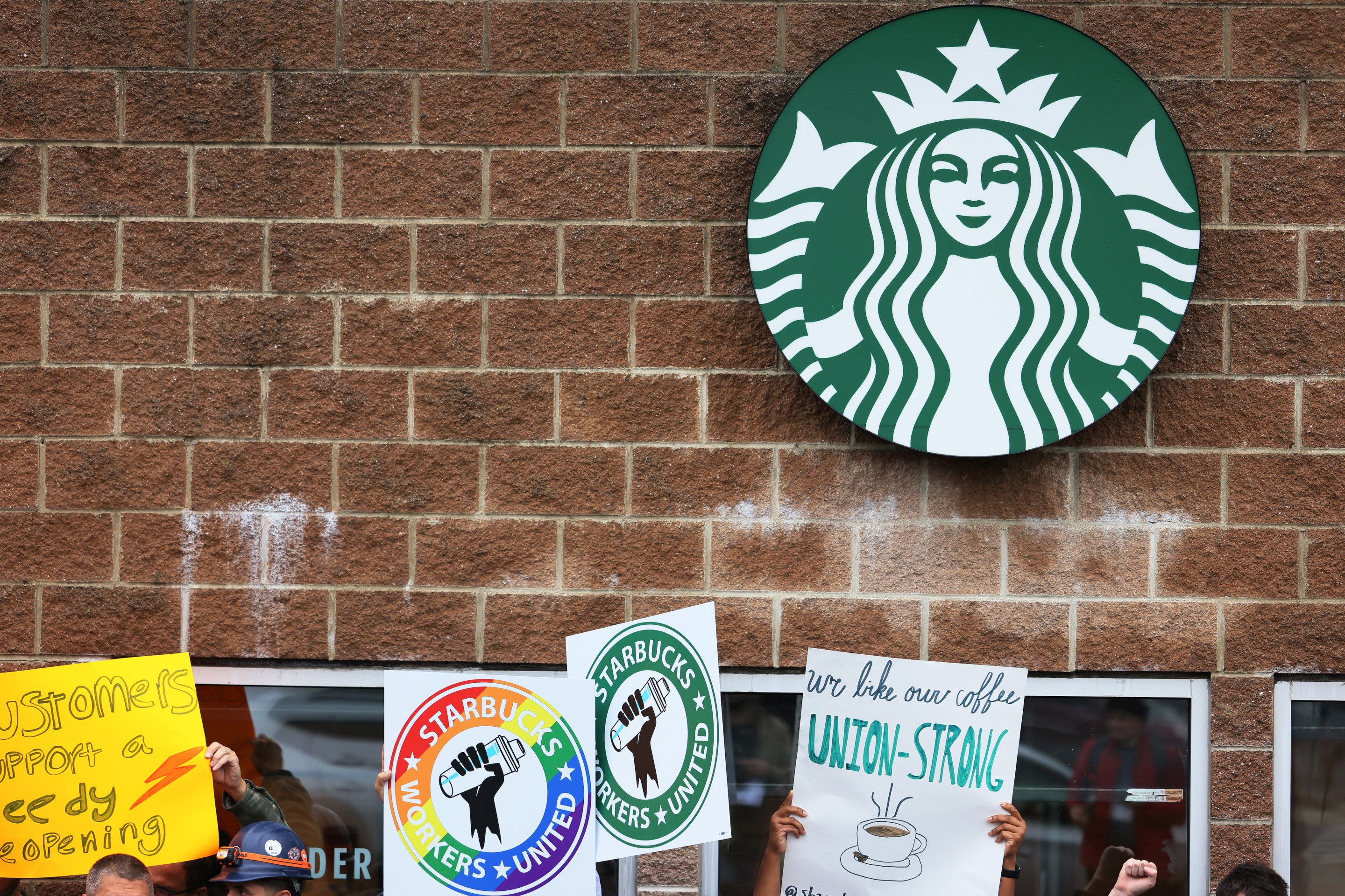 Starbucks workers hold a rally on October 05, 2022 in New York City. Starbucks Workers United were joined in solidarity by various unions as they held a rally outside of a Staten Island store, slated to close for renovations later this month. They are calling for the right to negotiate employment terms and want an end to the union busting campaign that is being used against workers throughout the country.