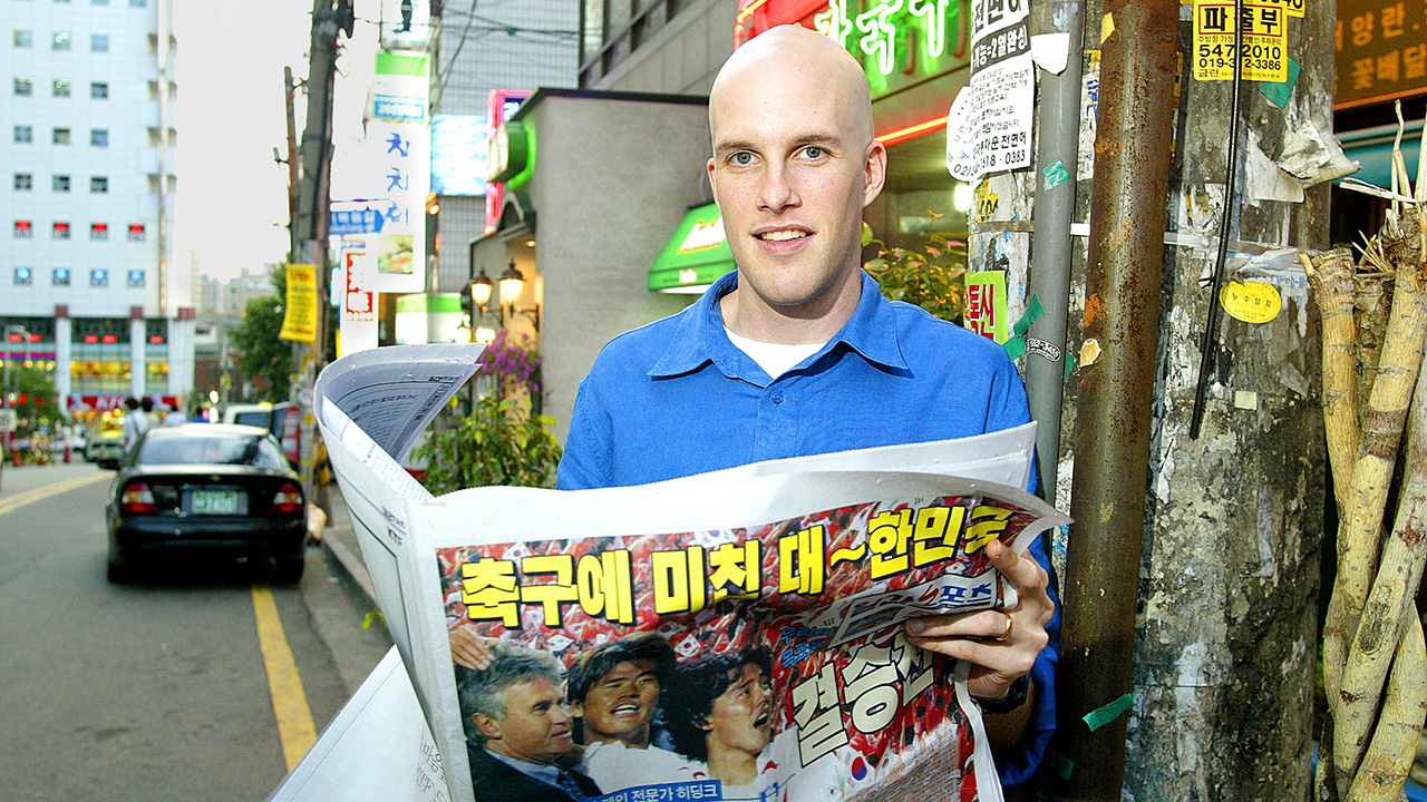 Soccer: FIFA World Cup: Closeup portrait of SI Senior Writer Grant Wahl reading South Korean newspaper on street. Seoul, South Korea 6/20/2002
