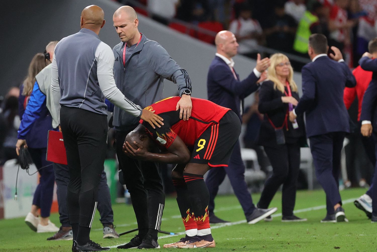 Belgium's assistant coach Thierry Henry consoles Belgium's Romelu Lukaku.