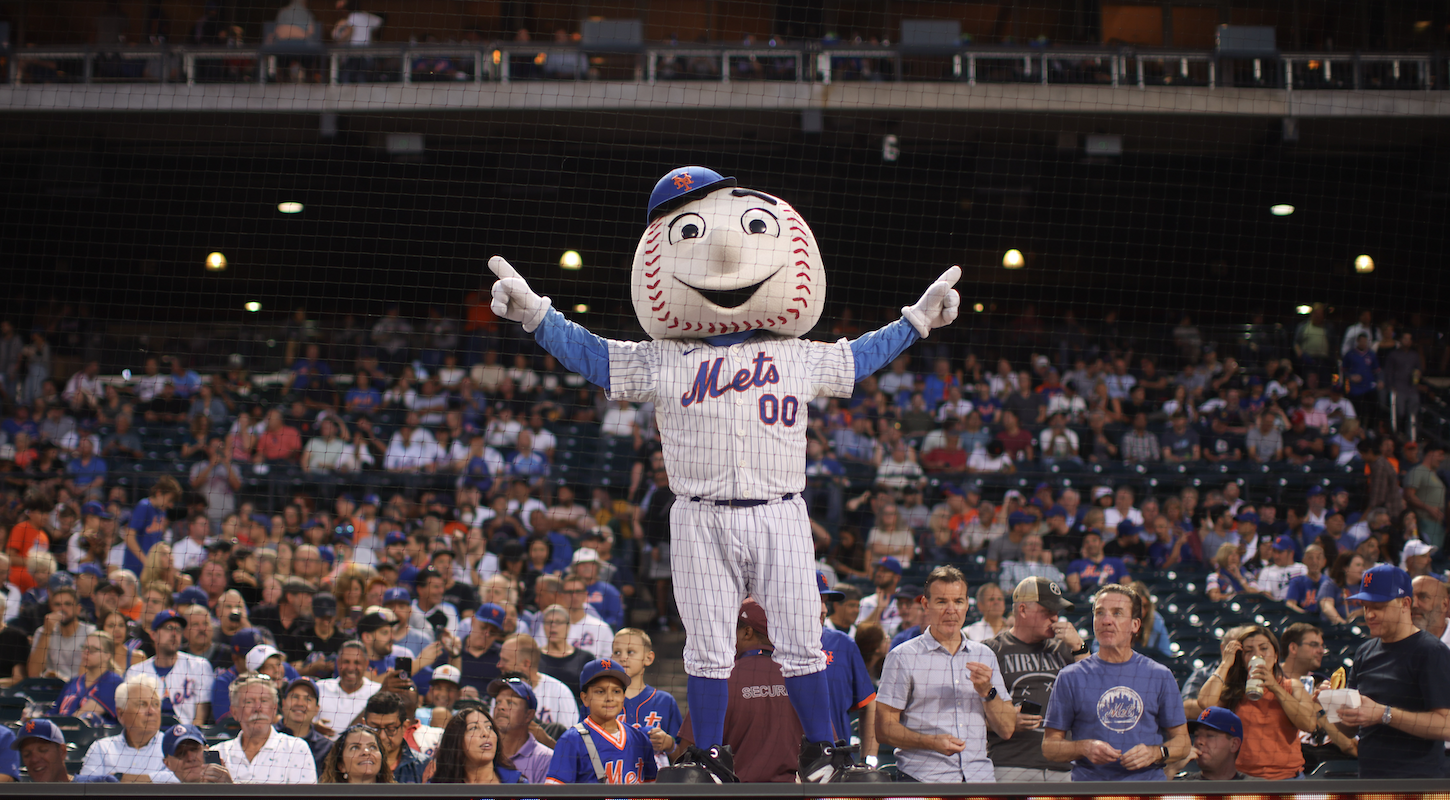Mr. Met stands on the dugout at a Mets game