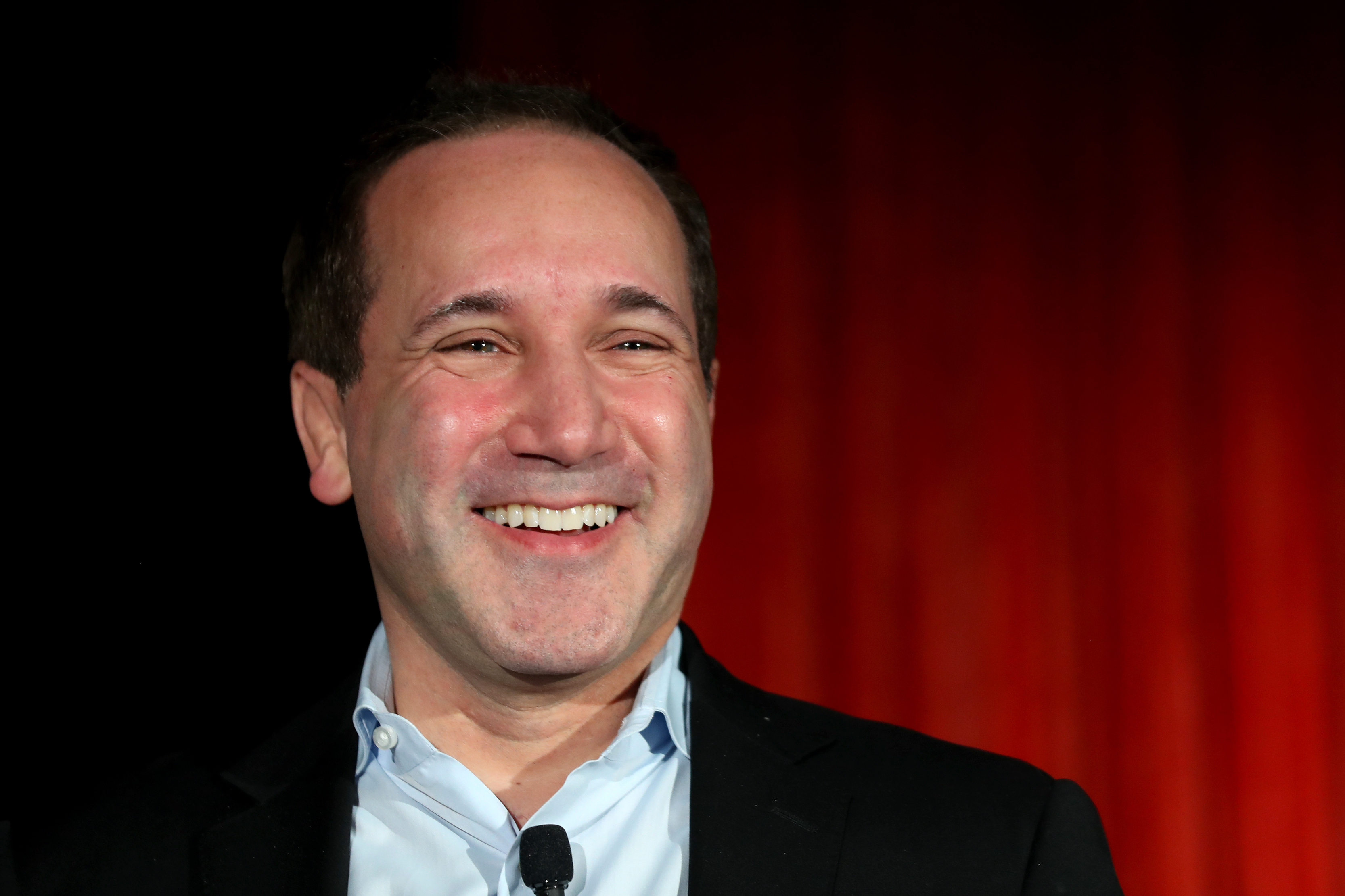Baltimore Orioles CEO John Angelos chuckling at a 2018 team event.