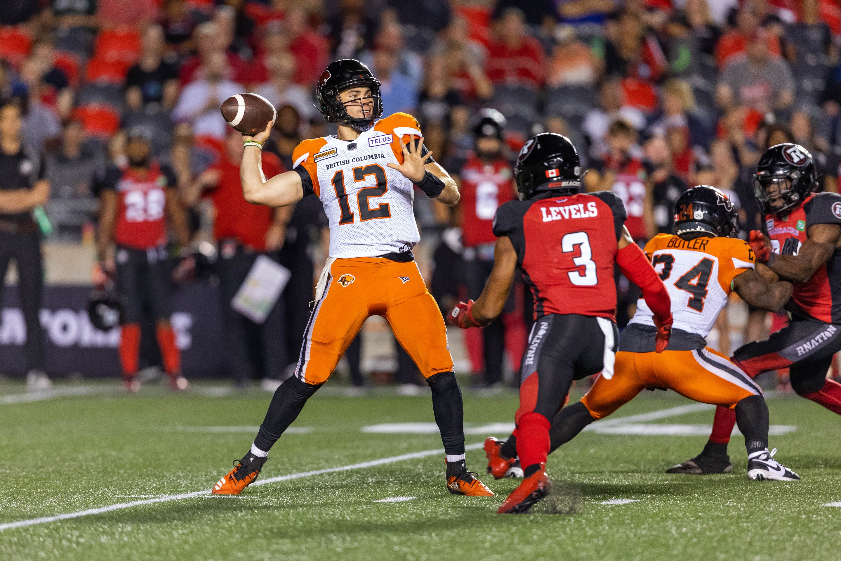 OTTAWA, ON - JUNE 30: BC Lions quarterback Nathan Rourke (12) looks to throw the ball during Canadian Football League action between the BC Lions and Ottawa Redblacks on June 30, 2022, at TD Place at Lansdowne Park in Ottawa, ON, Canada.