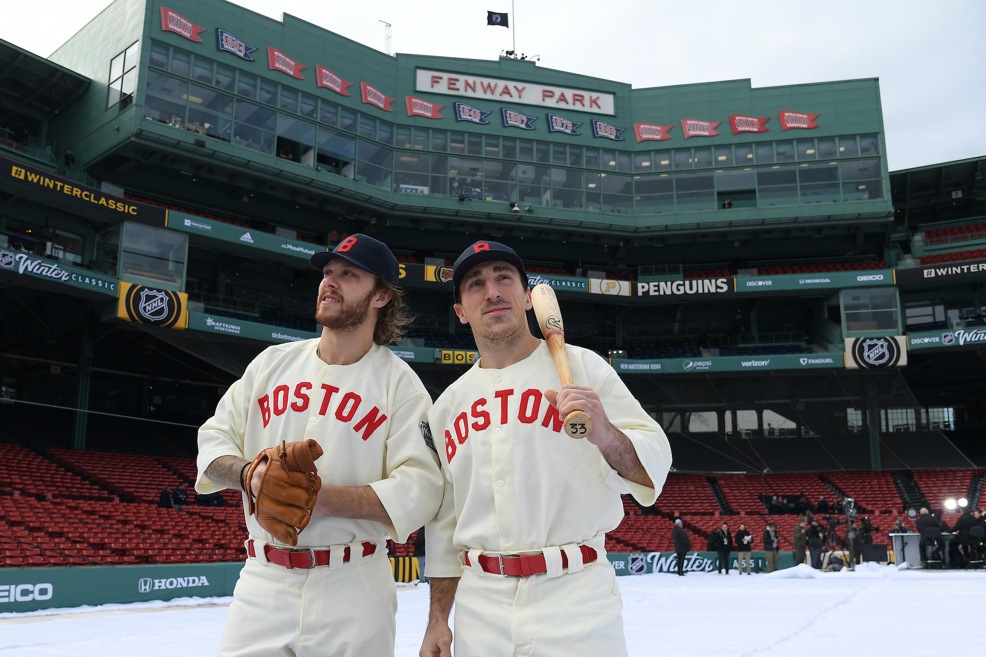 David Pastrnak #88 and Brad Marchand #63 of the Boston Bruins poses for a photo before the game against the Pittsburgh Penguins at the 2023 Discover NHL Winter Classic at Fenway Park on January 2, 2023 in Boston.