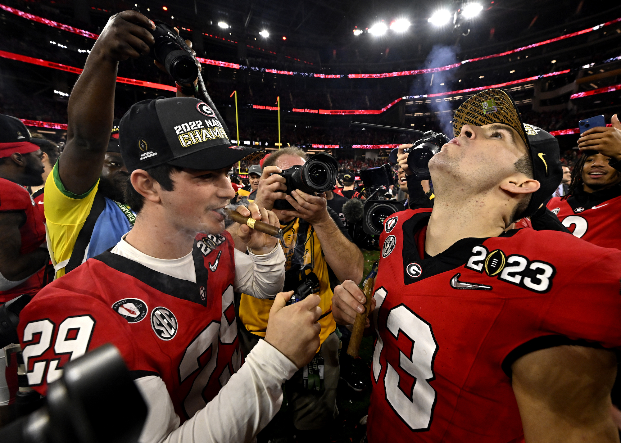 Inglewood, CA - January 09: Quarterback Stetson Bennett #13 of the Georgia Bulldogs lights a cigar with teammate wide receiver Luke Bennett #29 of the Georgia Bulldogs after defeating the TCU Horned Frogs 65-7 to win the CFP National Championship Football game at SoFi Stadium in Inglewood on Monday, January 9, 2023. (Photo by Keith Birmingham/MediaNews Group/Pasadena Star-News via Getty Images)