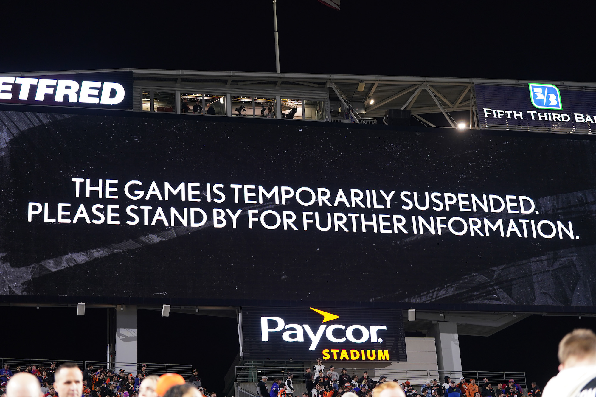 An announcement is displayed on the scoreboard after the game was temporarily suspended following the collapse of Damar Hamlin #3 of the Buffalo Bills after making a tackle against the Cincinnati Bengals at Paycor Stadium on January 02, 2023 in Cincinnati, Ohio. (Photo by Dylan Buell/Getty Images)