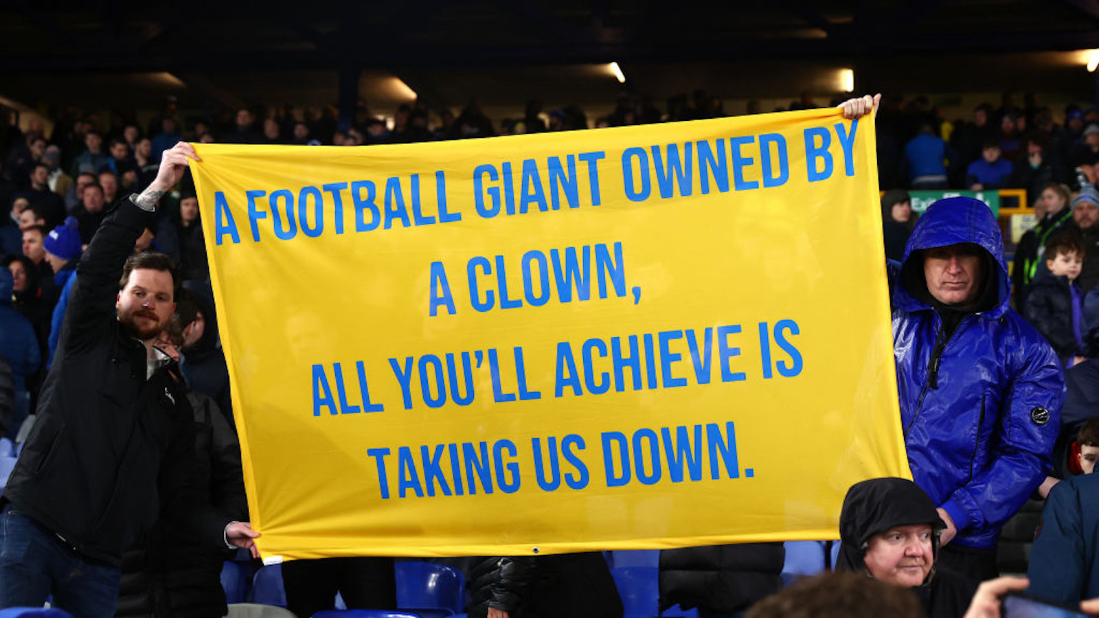 Everton fans hold up a protest sign