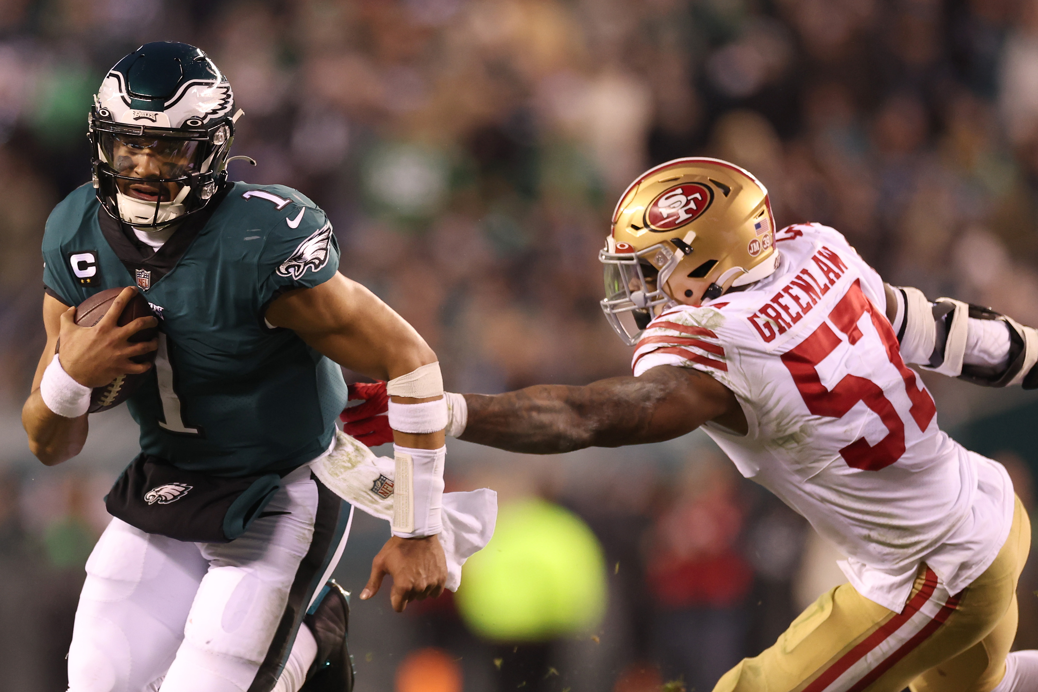 Eagles quarterback Jalen Hurts runs past Dre Greenlaw of the 49ers in Philadelphia's 31-7 win in the NFC Conference Championship.