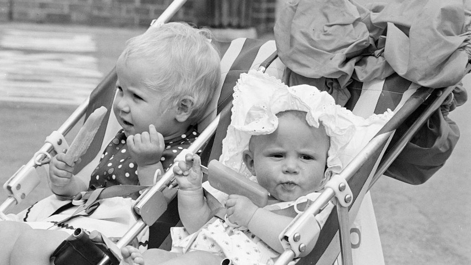 Two babies holding popsicles