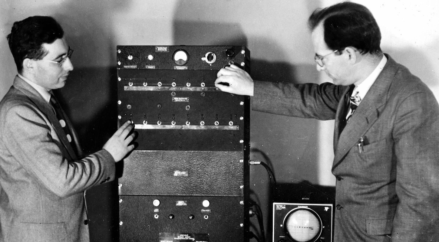 Old-timey scientists fiddle with knobs and toggles on a contraption