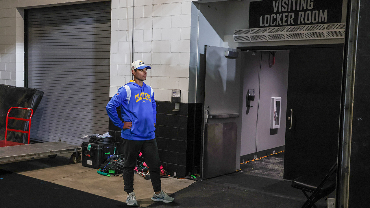 Jacksonville, Florida, January 14, 2023 - Head coach Brandon Staley stands washes in stunned silence outside the locker room, waiting for all his players to leave the field after losing 32-30 to the Jacksonville Jaguars in an AFC Wild Card game at TIAA Bank Field.