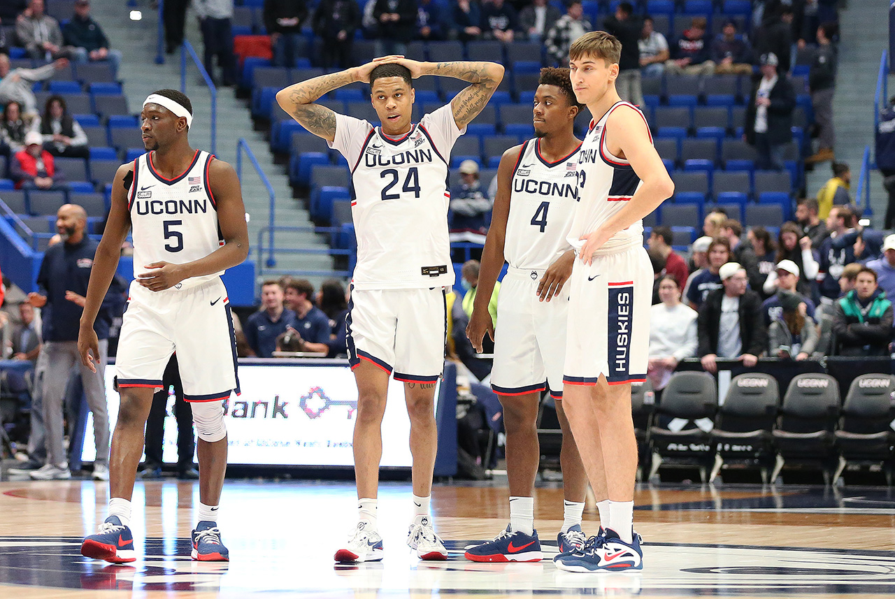 HARTFORD, CT - JANUARY 15: UConn Huskies guard Jordan Hawkins (24) reacts as UConn Huskies guard Hassan Diarra (5), UConn Huskies guard Nahiem Alleyne (4) and UConn Huskies guard Apostolos Roumoglou (33) look on during the college basketball game between St John's Red Storm and UConn Huskies on January 15, 2023, at the XL Center in Hartford, CT.
