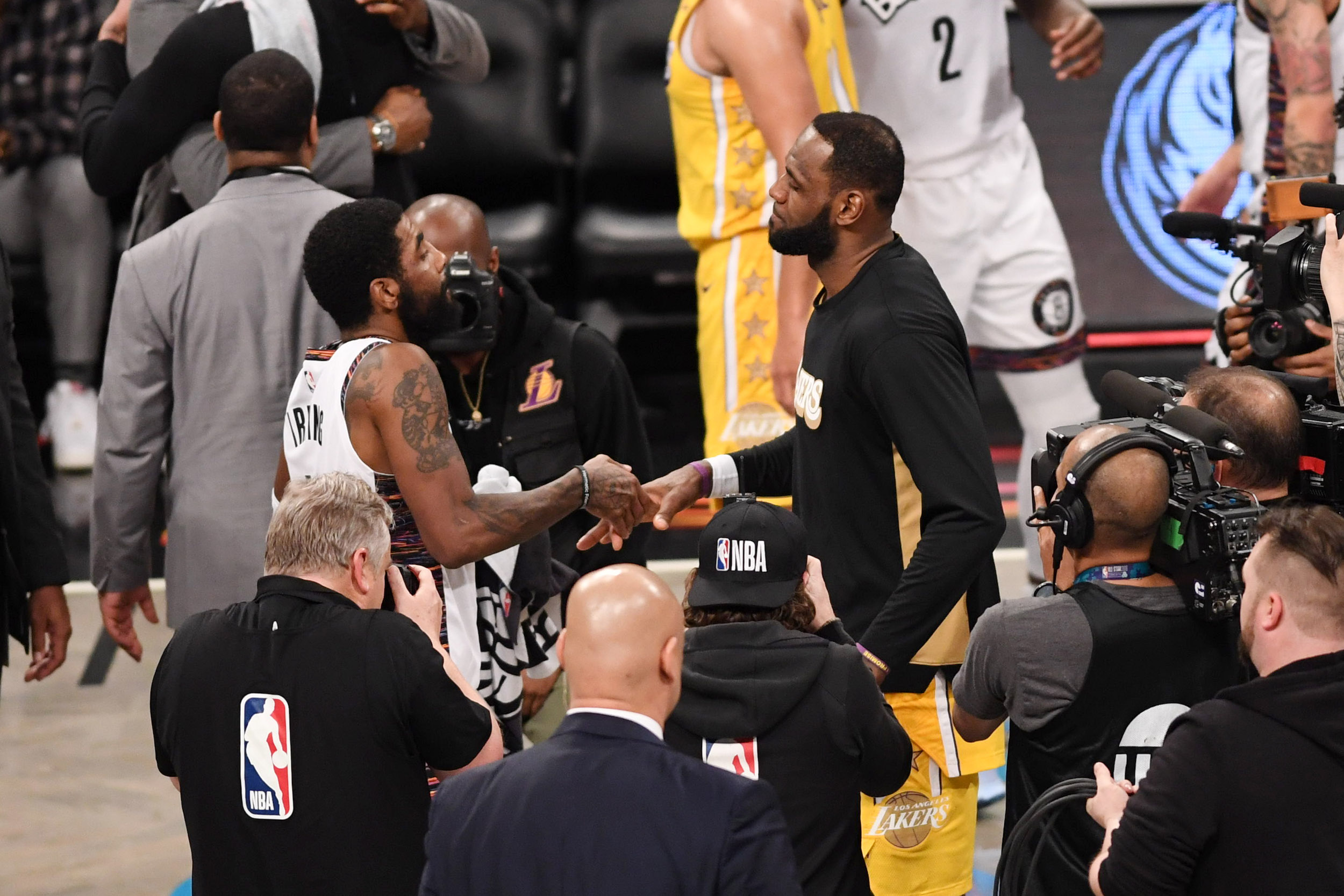 LeBron James and Kyrie Irving shake hands.
