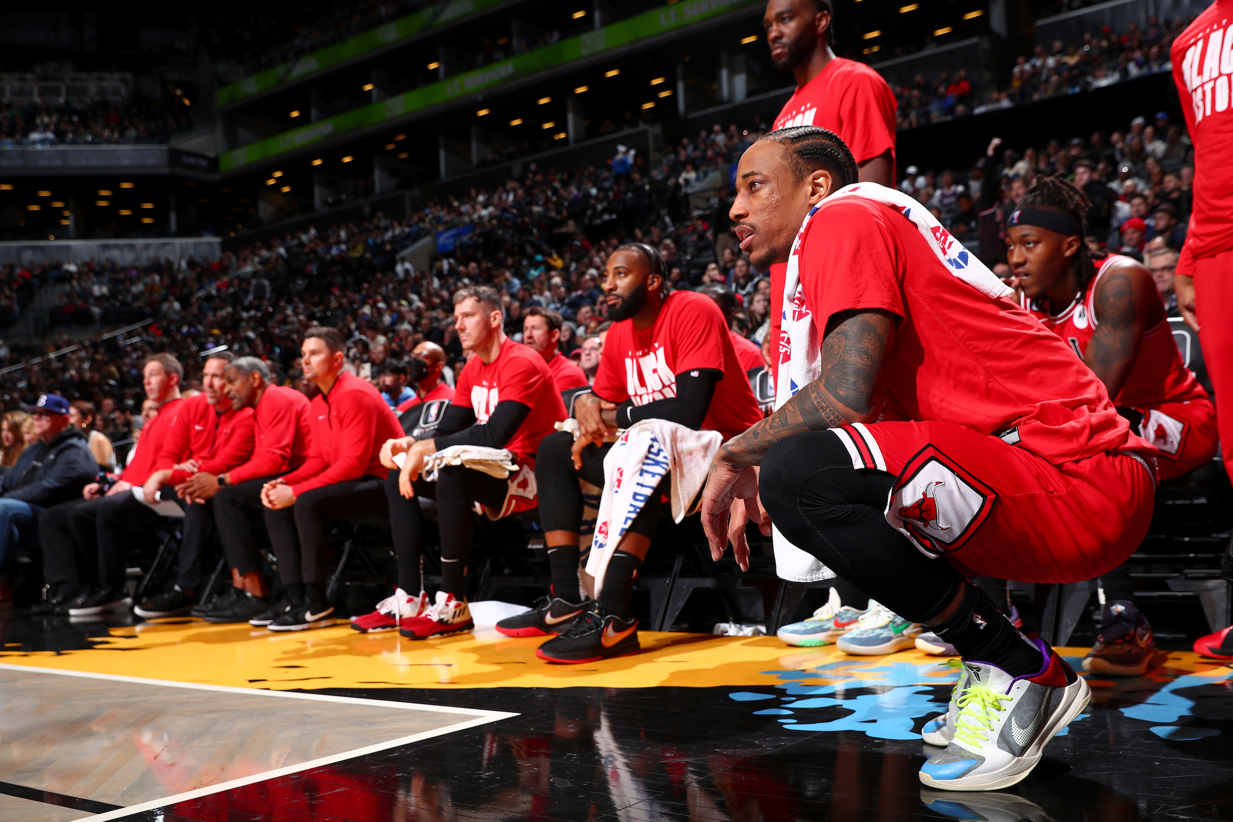 Bulls players watch from the bench.