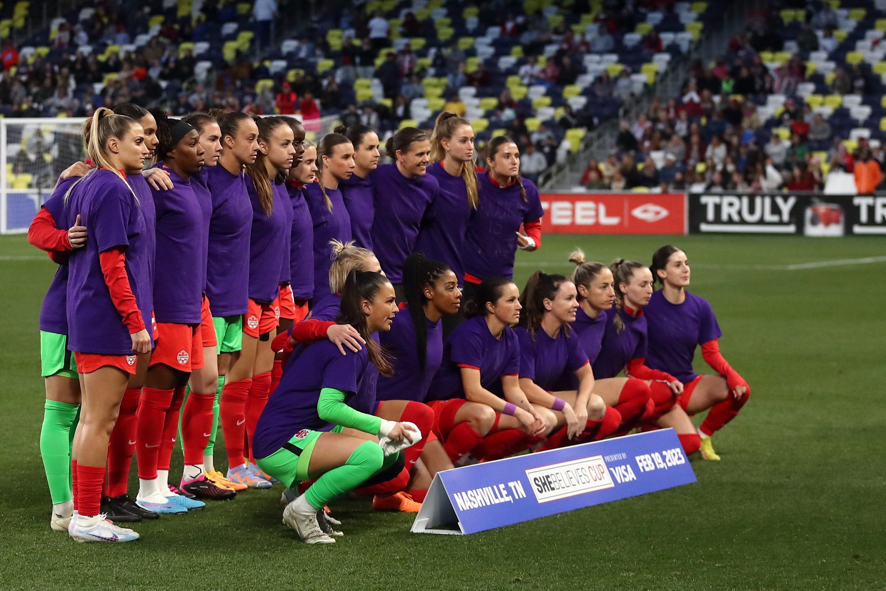Canada team group as the players wear purple t shirts with enough is enough written on them during the 2023 SheBelieves Cup match between Canada and Brazil at GEODIS Park on February 19, 2023 in Nashville, Tennessee