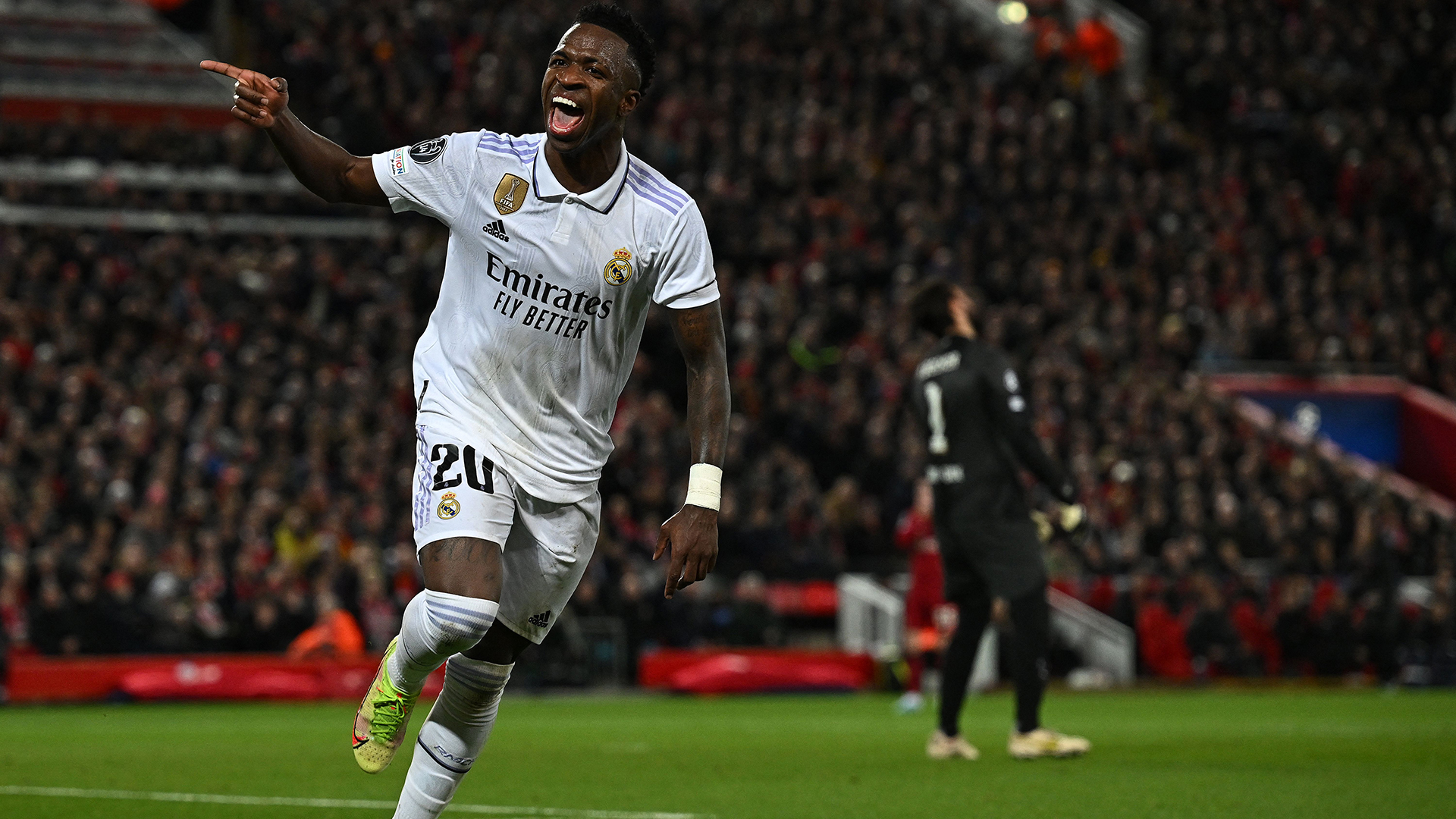 Liverpool's Brazilian goalkeeper Alisson Becker reacts as Real Madrid's Brazilian forward Vinicius Junior celebrates scoring the team's second goal during the UEFA Champions League last 16 first leg football match between Liverpool and Real Madrid at Anfield in Liverpool, north west England on February 21, 2023.