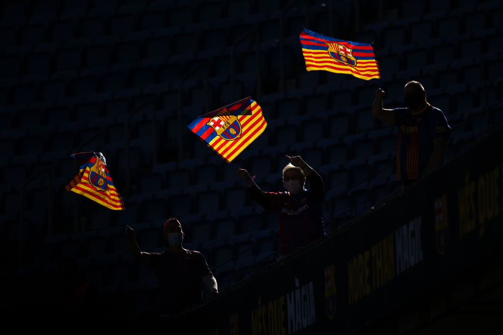 Fans are seen waving flags inside the stadium as they await the unveiling of new FC Barcelona Head Coach Xavi Hernandez during a press conference at Camp Nou on November 08, 2021 in Barcelona, Spain. (Photo by David Ramos/Getty Images)