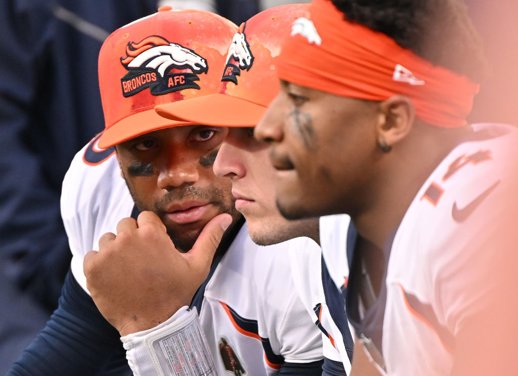CHARLOTTE, NORTH CAROLINA - NOVEMBER 27: Russell Wilson #3 of the Denver Broncos confers with teammates on the sideline during their game against the Carolina Panthers at Bank of America Stadium on November 27, 2022 in Charlotte, North Carolina.