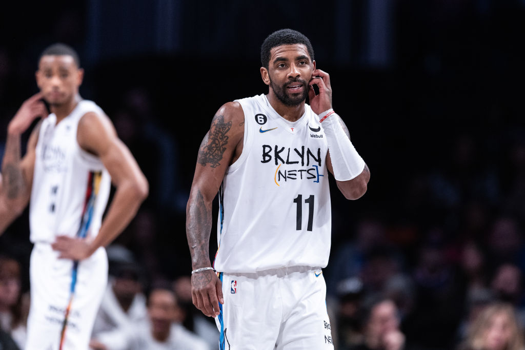 Kyrie Irving scratches his face