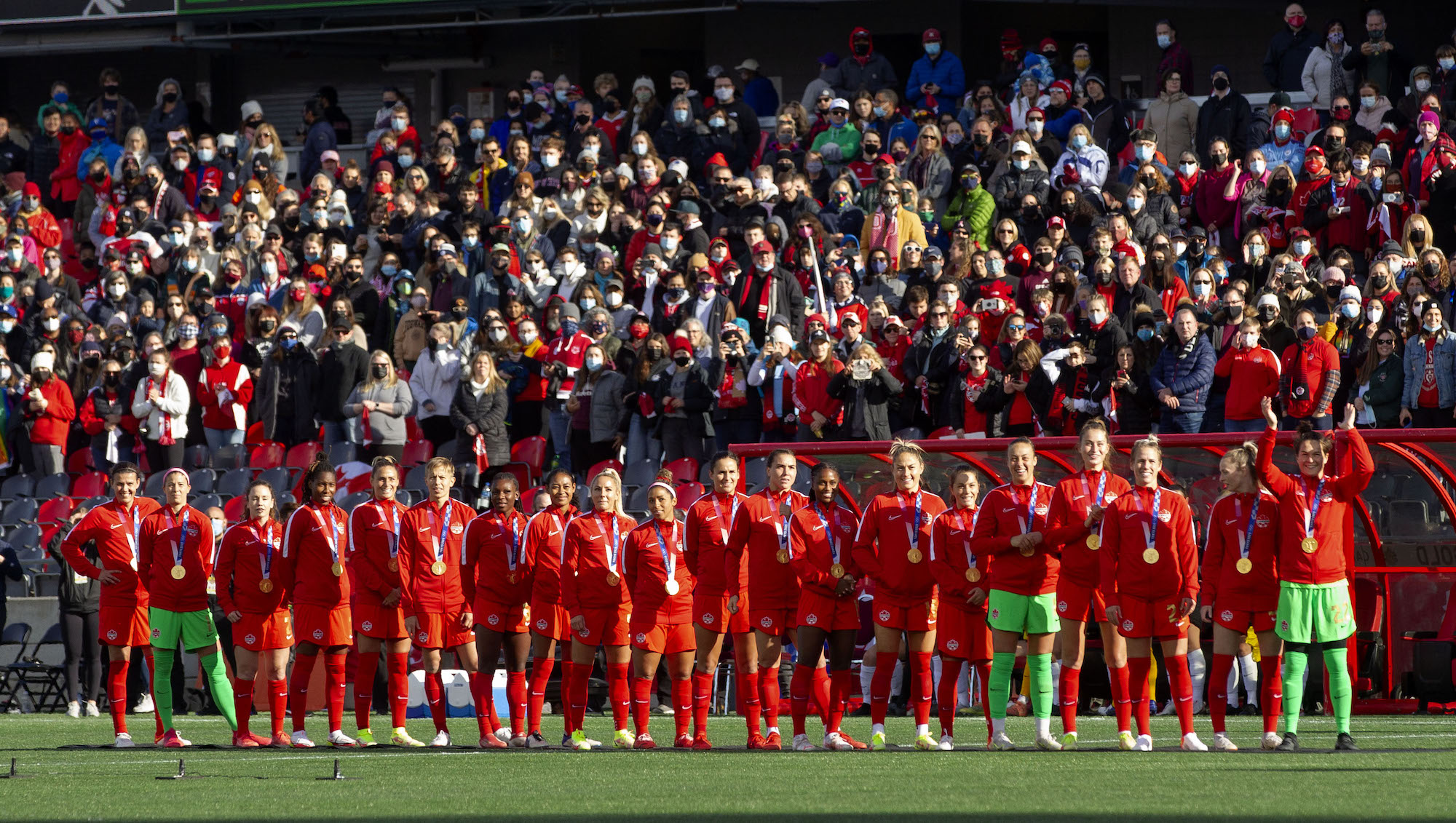 Team Canada stands at mid-field with their Olympic Gold Medals before the first of the Canadian Women's National Team Olympic Gold Medal Celebration Tour games against the New Zealand Womens Football Ferns national team.