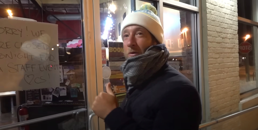 Barstool Sports founder Dave Portnoy stands in front of a pizza shop with a sign that clearly says it's closed for a staff party.