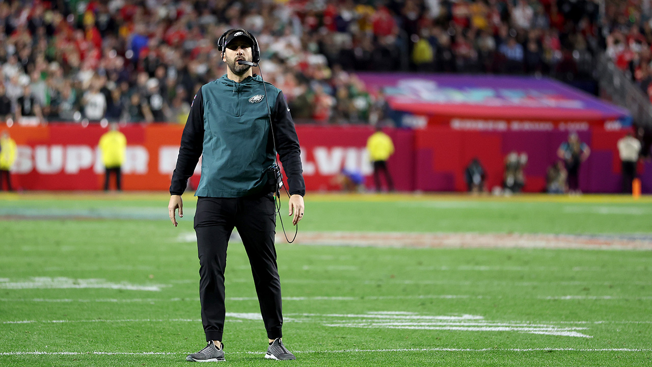 GLENDALE, ARIZONA - FEBRUARY 12: Head coach Nick Sirianni of the Philadelphia Eagles looks on against the Kansas City Chiefs in Super Bowl LVII at State Farm Stadium on February 12, 2023 in Glendale, Arizona. He's standing alone in the middle of the field (which is in awful shape).