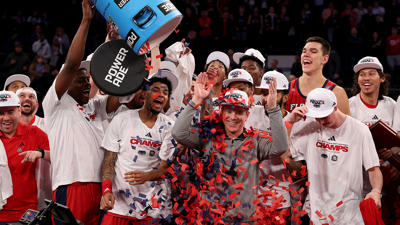 NEW YORK, NEW YORK - MARCH 25: Head coach Dusty May of the Florida Atlantic Owls celebrates with the team after defeating the Kansas State Wildcats in the Elite Eight round game of the NCAA Men's Basketball Tournament at Madison Square Garden on March 25, 2023 in New York City.