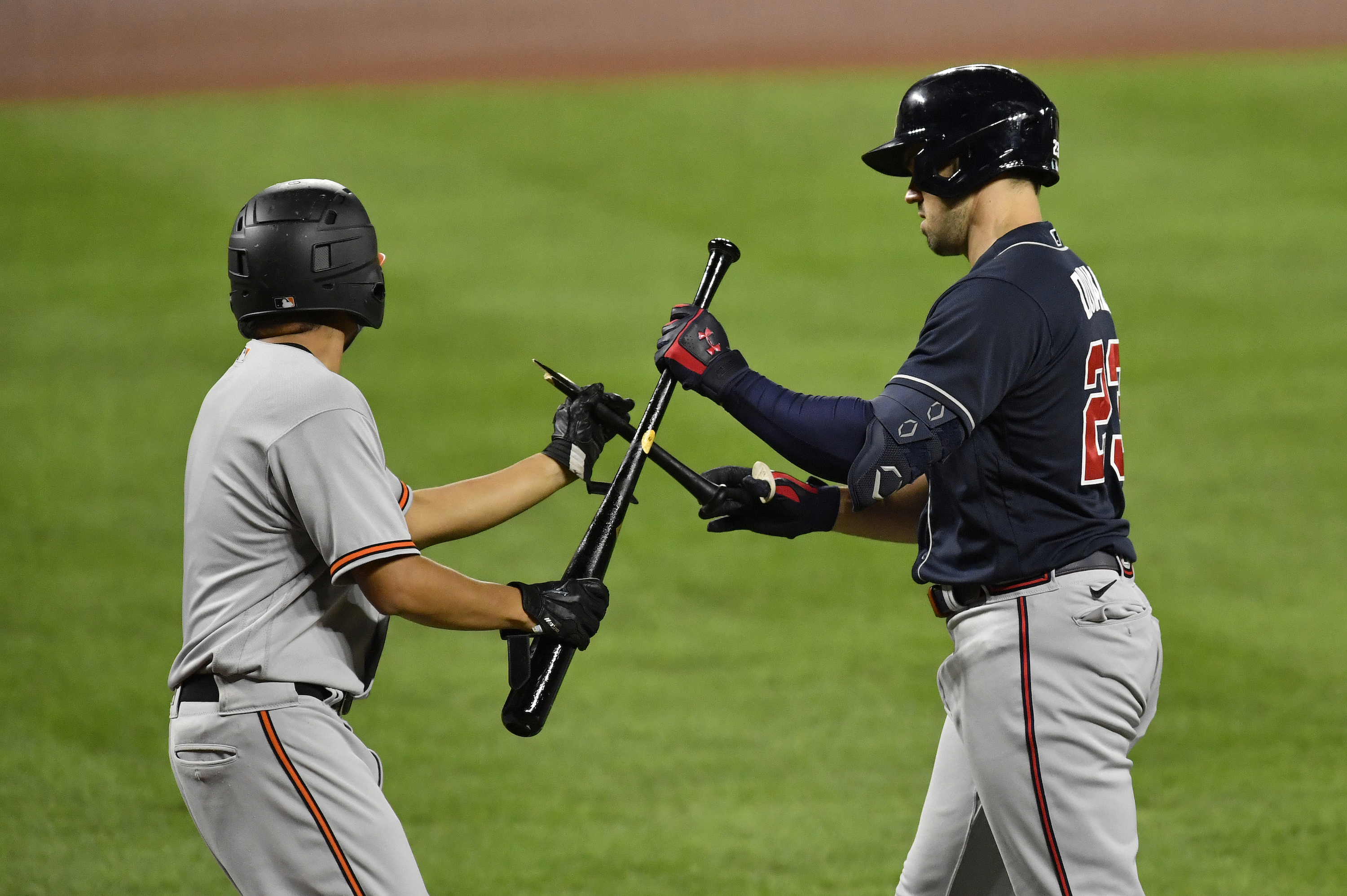 Atlanta Braves left fielder Adam Duvall (23) exchanges a broken bat handle for a new bat with a bat boy during the Atlanta Braves vs. Baltimore Orioles MLB game at Oriole Park at Camden Yards on September 15, 2020 in Baltimore, MD.