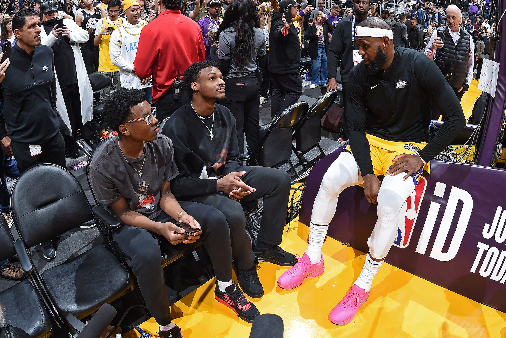 LOS ANGELES, CA - FEBRUARY 7: Brice James, Bronny James and LeBron James #6 of the Los Angeles Lakers talk during the game against the Oklahoma City Thunder on February 7, 2023 at Crypto.Com Arena in Los Angeles, California. NOTE TO USER: User expressly acknowledges and agrees that, by downloading and/or using this Photograph, user is consenting to the terms and conditions of the Getty Images License Agreement. Mandatory Copyright Notice: Copyright 2023 NBAE (Photo by Andrew D. Bernstein/NBAE via Getty Images)