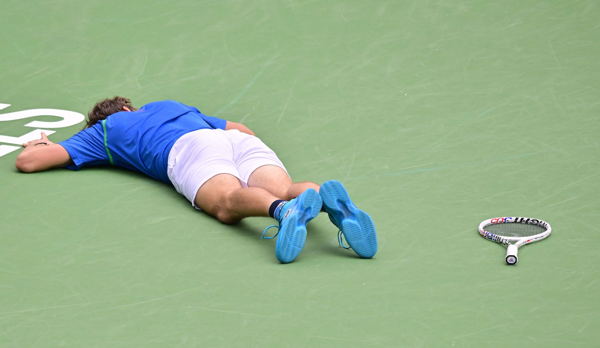 Daniil Medvedev lies on the court during his fourth-round match at Indian Wells.