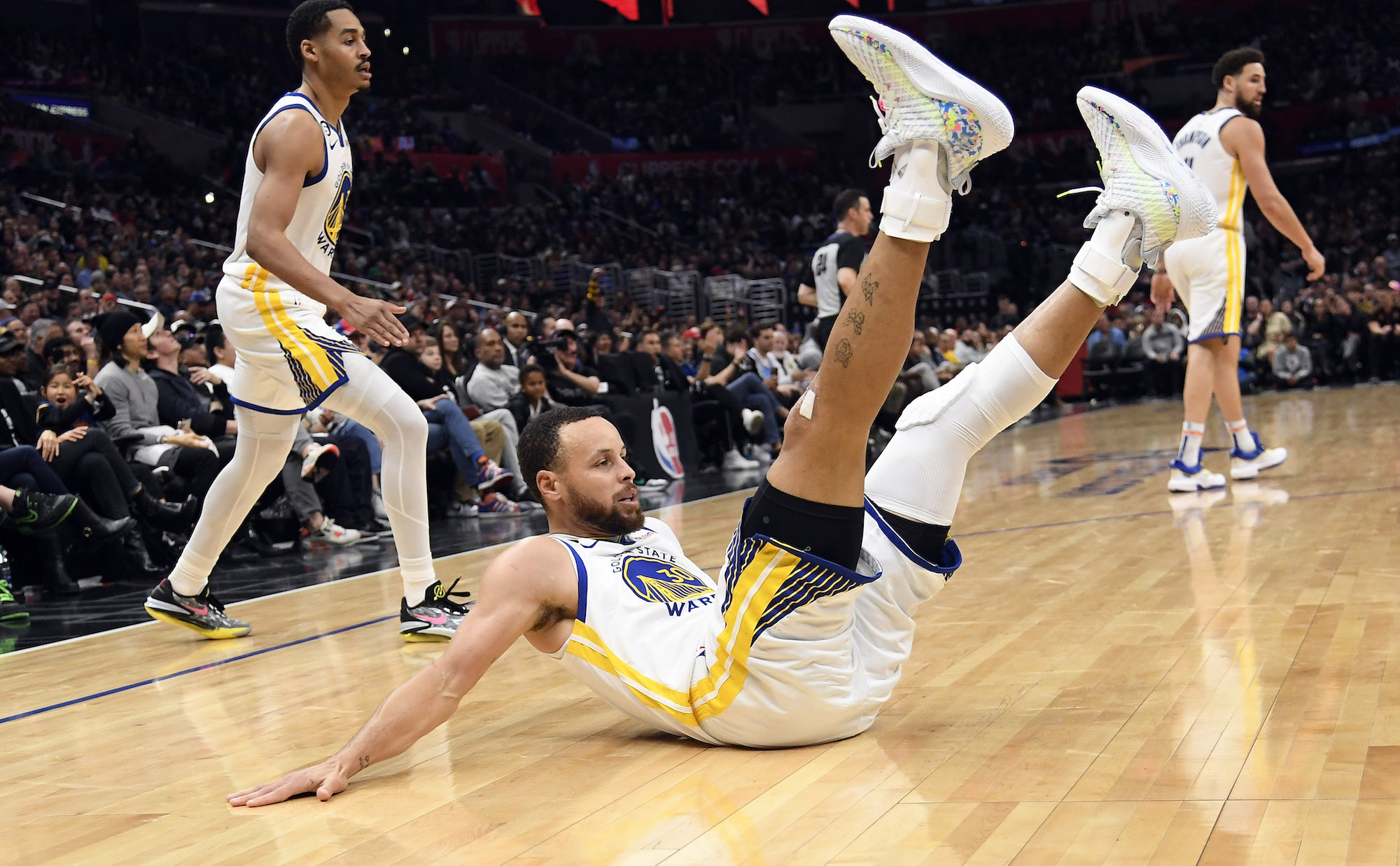 LOS ANGELES, CA - MARCH 15: Stephen Curry #30 of the Golden State Warriors falls to the ground after scoring a basket during the second half against Los Angeles Clippers at Crypto.com Arena on March 15, 2023 in Los Angeles, California. NOTE TO USER: User expressly acknowledges and agrees that, by downloading and or using this photograph, User is consenting to the terms and conditions of the Getty Images License Agreement. (Photo by Kevork Djansezian/Getty Images)