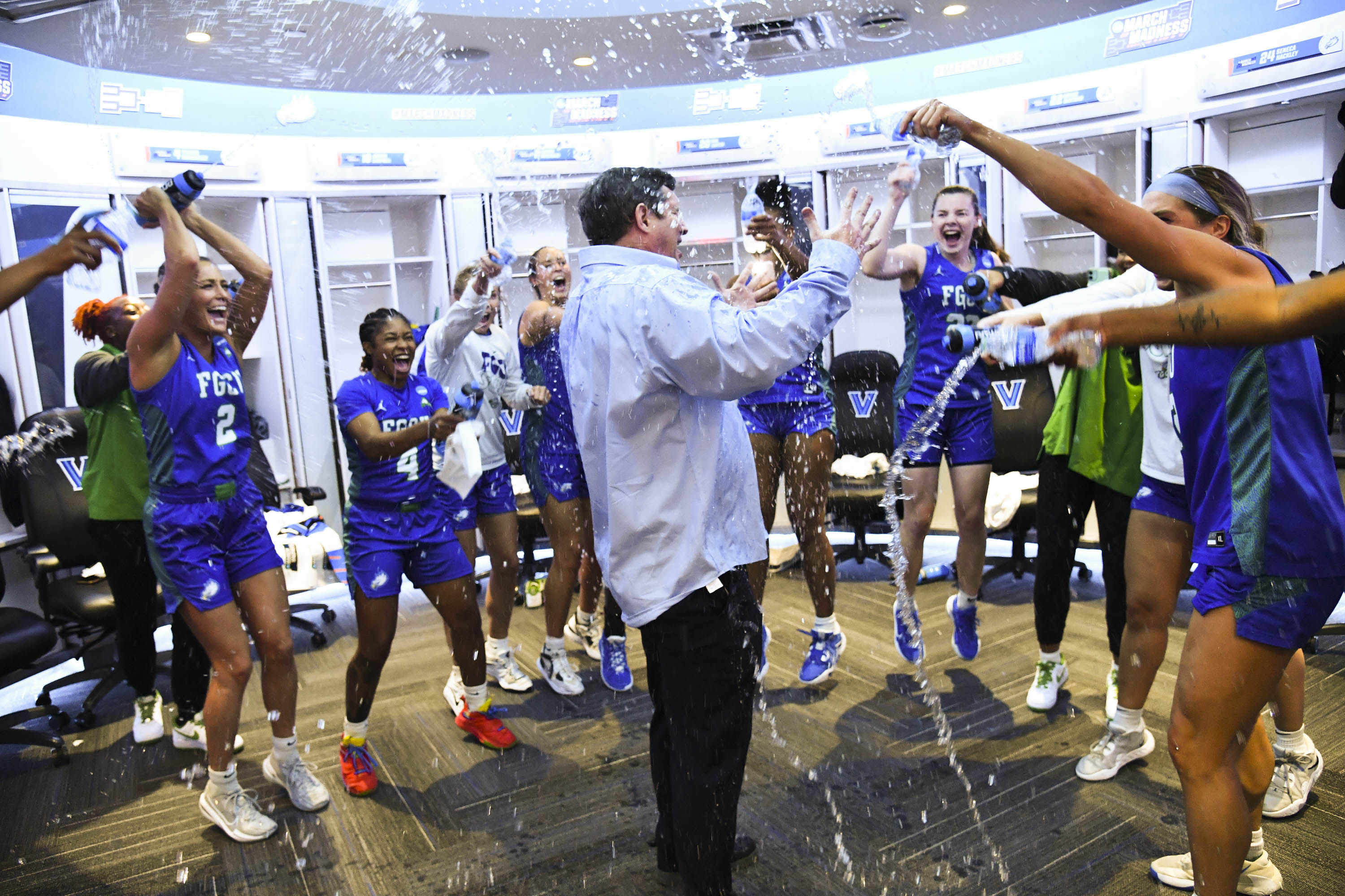 Head coach Karl Smesko gets doused by his team as he enters the locker room following the first round of the 2023 NCAA Women's Basketball Tournament held at Finneran Pavilion on March 18, 2023 in Villanova, Pennsylvania.