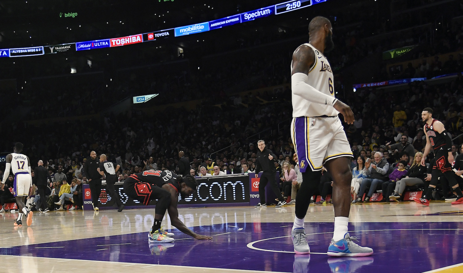 LOS ANGELES, CA - MARCH 26: Patrick Beverley #21 of the Chicago Bulls touches the Los Angeles Lakers basketball court as he celebrates after scoring a basket against LeBron James #6 of the Los Angeles Lakers in the closing minute of the game at Crypto.com Arena on March 26, 2023 in Los Angeles, California. NOTE TO USER: User expressly acknowledges and agrees that, by downloading and or using this photograph, User is consenting to the terms and conditions of the Getty Images License Agreement.(Photo by Kevork Djansezian/Getty Images)