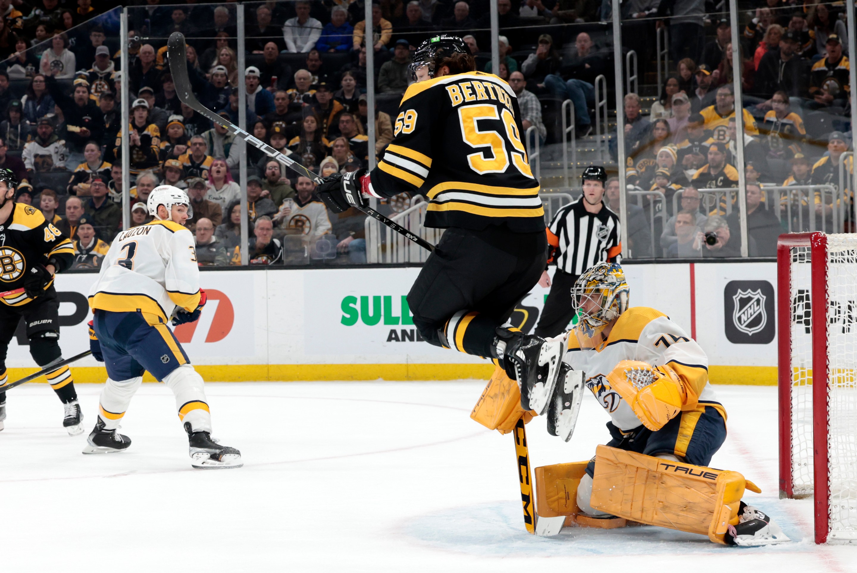 Tyler Bertuzzi leaps to avoid a shot on Juuse Saros