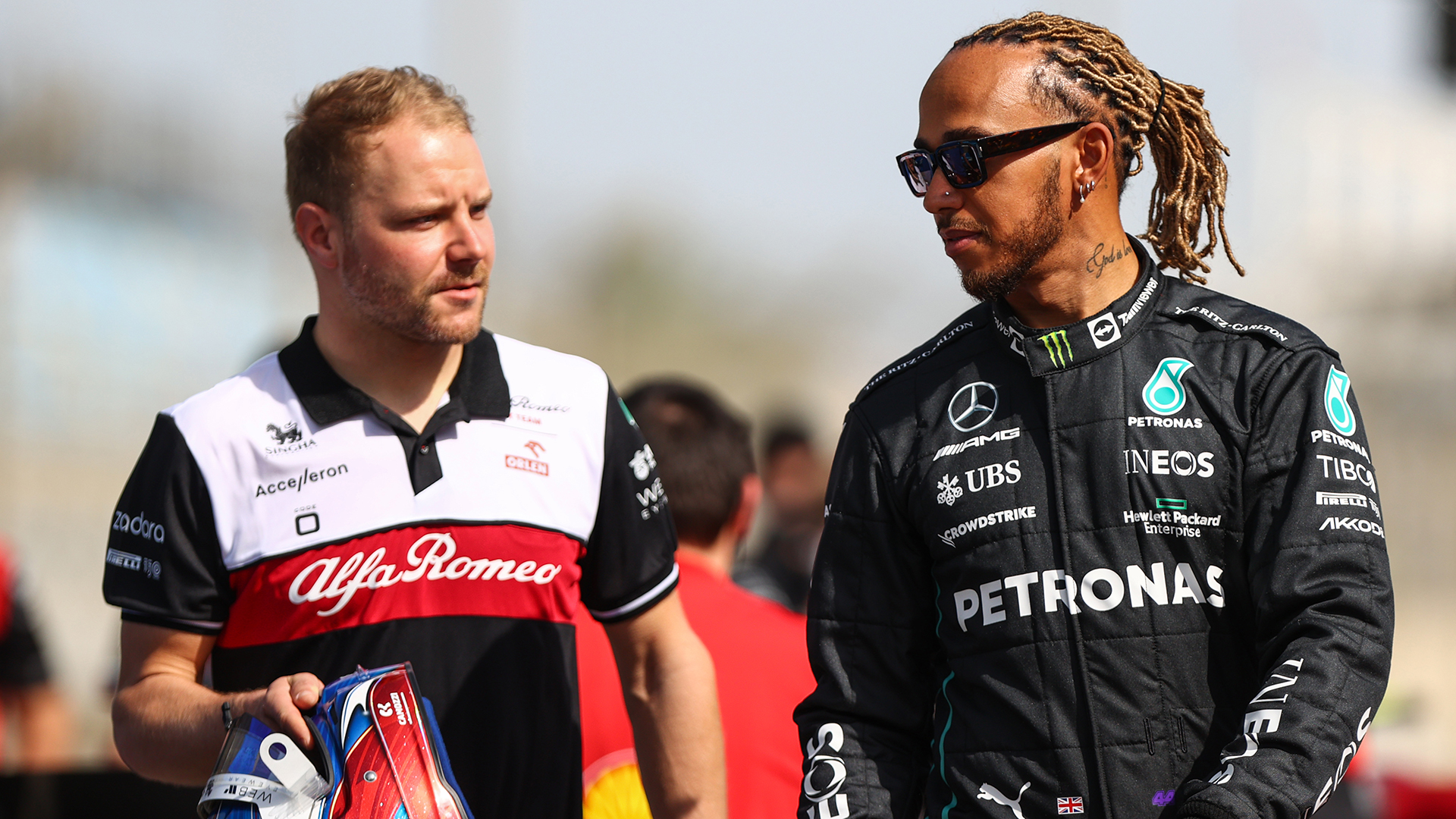 Lewis Hamilton of Great Britain and Mercedes talks with Valtteri Bottas of Finland and Alfa Romeo F1 during Day One of F1 Testing at Bahrain International Circuit on March 10, 2022 in Bahrain, Bahrain.