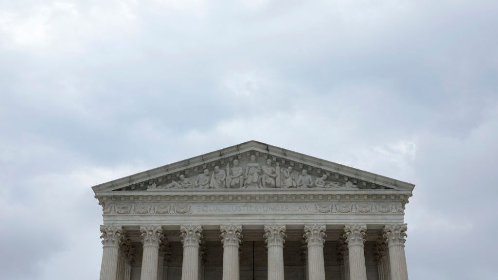 A view of the U.S. Supreme Court Building on May 16, 2022 in Washington, DC. The building looks darks and the background behind it is cloudy.