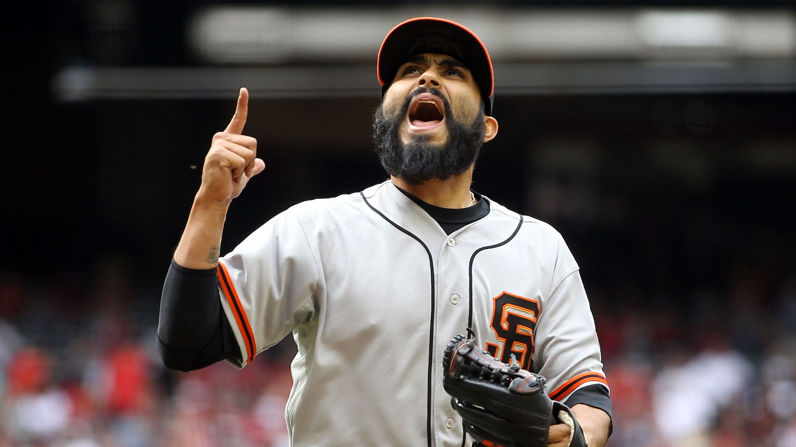 Relief pitcher Sergio Romo #54 of the San Francisco Giants reacts after getting out of the seventh inning against the Arizona Diamondbacks during the MLB game at Chase Field on April 8, 2012 in Phoenix, Arizona.