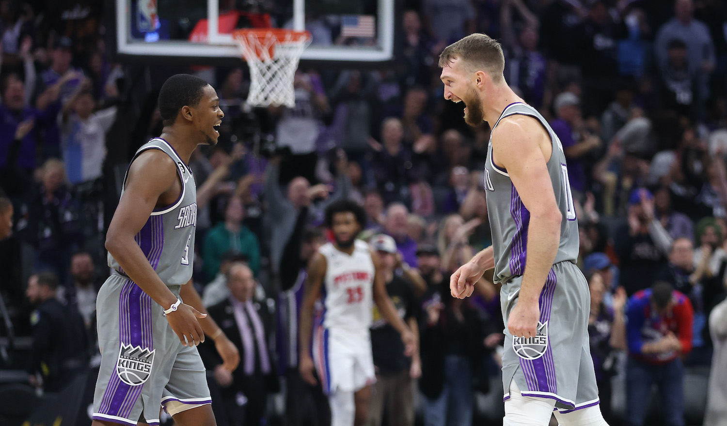 SACRAMENTO, CALIFORNIA - NOVEMBER 20: De'Aaron Fox #5 and Domantas Sabonis #10 of the Sacramento Kings celebrate after a three-point basket in the fourth quarter against the Detroit Pistons at Golden 1 Center on November 20, 2022 in Sacramento, California. NOTE TO USER: User expressly acknowledges and agrees that, by downloading and/or using this photograph, User is consenting to the terms and conditions of the Getty Images License Agreement. (Photo by Lachlan Cunningham/Getty Images)