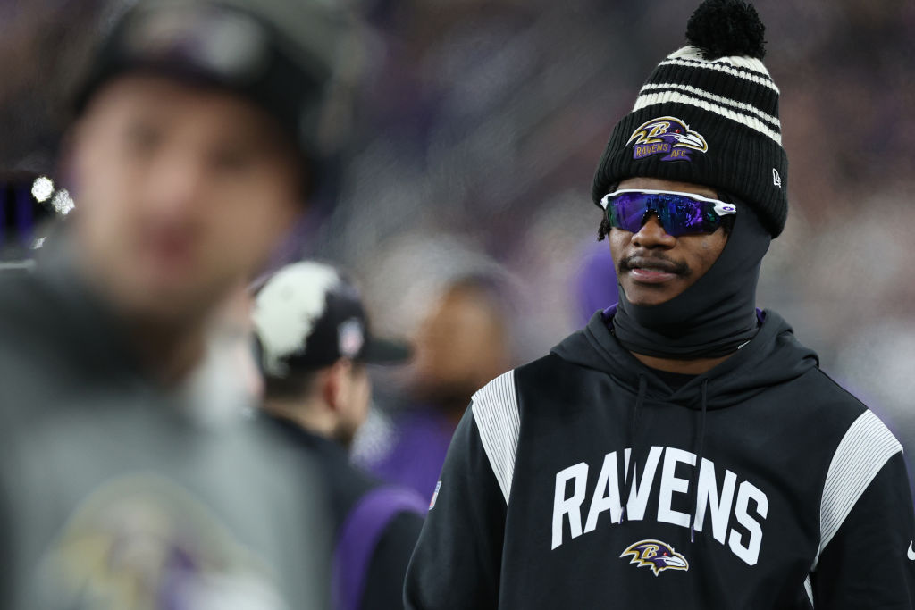 Lamar Jackson looks on from the sideline