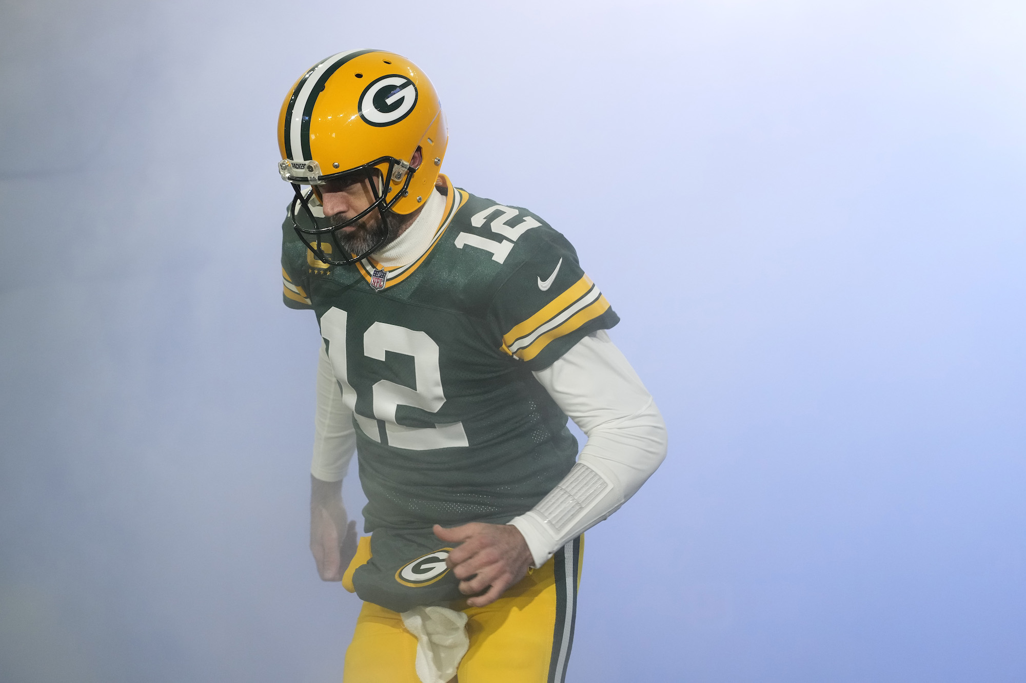 GREEN BAY, WISCONSIN - JANUARY 08: Aaron Rodgers #12 of the Green Bay Packers runs onto the field before a game against the Detroit Lions at Lambeau Field on January 08, 2023 in Green Bay, Wisconsin. (Photo by Patrick McDermott/Getty Images)