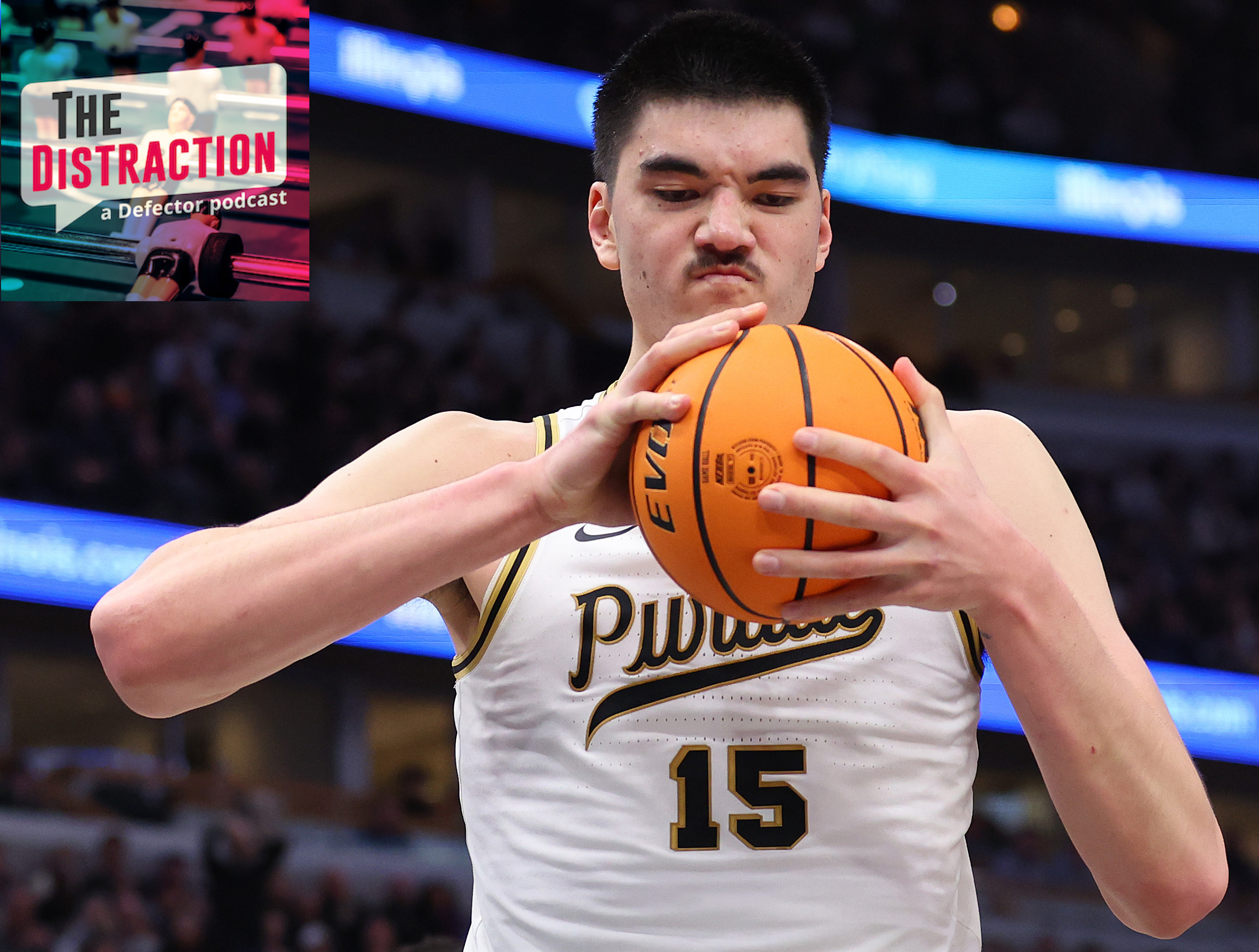 Purdue center Zach Edey scowls at and squeezes a basketball during the Big Ten Championship Game against Penn State.