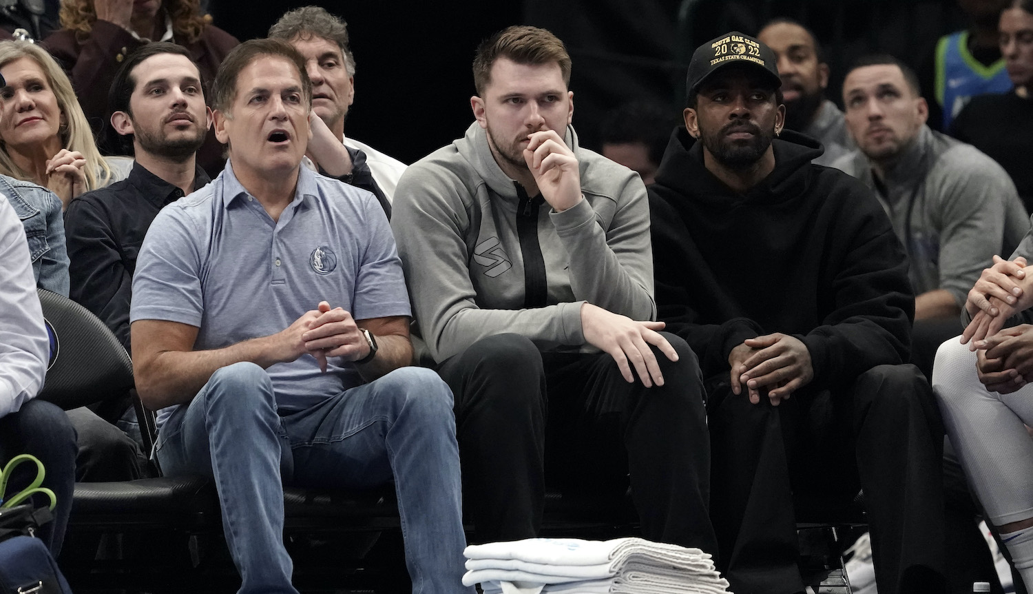 DALLAS, TEXAS - MARCH 13: (L-R) Dallas Mavericks owner Mark Cuban, Luka Doncic and Kyrie Irving watch first-half play against the Memphis Grizzlies at American Airlines Center on March 13, 2023 in Dallas, Texas. NOTE TO USER: User expressly acknowledges and agrees that, by downloading and/or using this Photograph, user is consenting to the terms and conditions of the Getty Images License Agreement. (Photo by Sam Hodde/Getty Images)