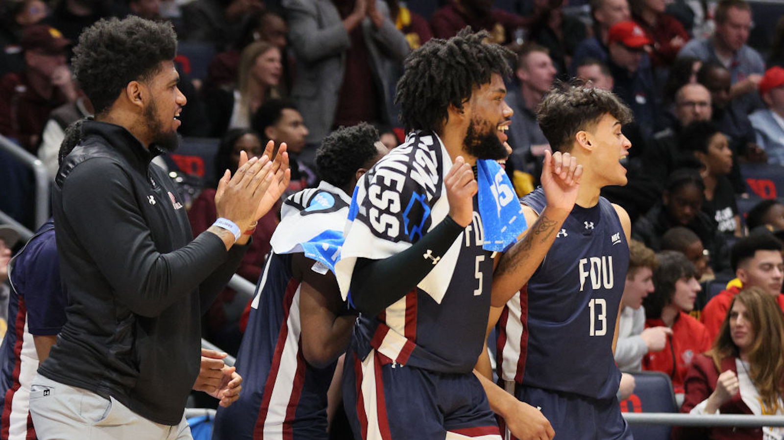 DAYTON, OHIO - MARCH 15: Ansley Almonor #5 and Jo'el Emanuel #13 of the Fairleigh Dickinson Knights celebrate after defeating the Texas Southern Tigers in the First Four game of the NCAA Men's Basketball Tournament at University of Dayton Arena on March 15, 2023 in Dayton, Ohio.