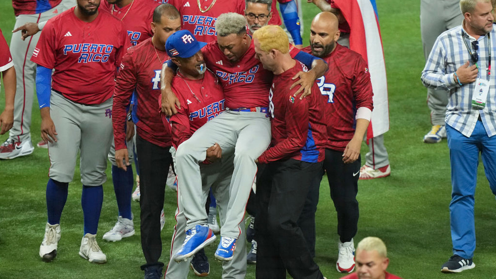 MIAMI, FLORIDA - MARCH 15: Edwin Diaz #39 of Puerto Rico is helped off the field after being injured during the on-field celebration after defeating the Dominican Republic during the World Baseball Classic Pool D at loanDepot park on March 15, 2023 in Miami, Florida.
