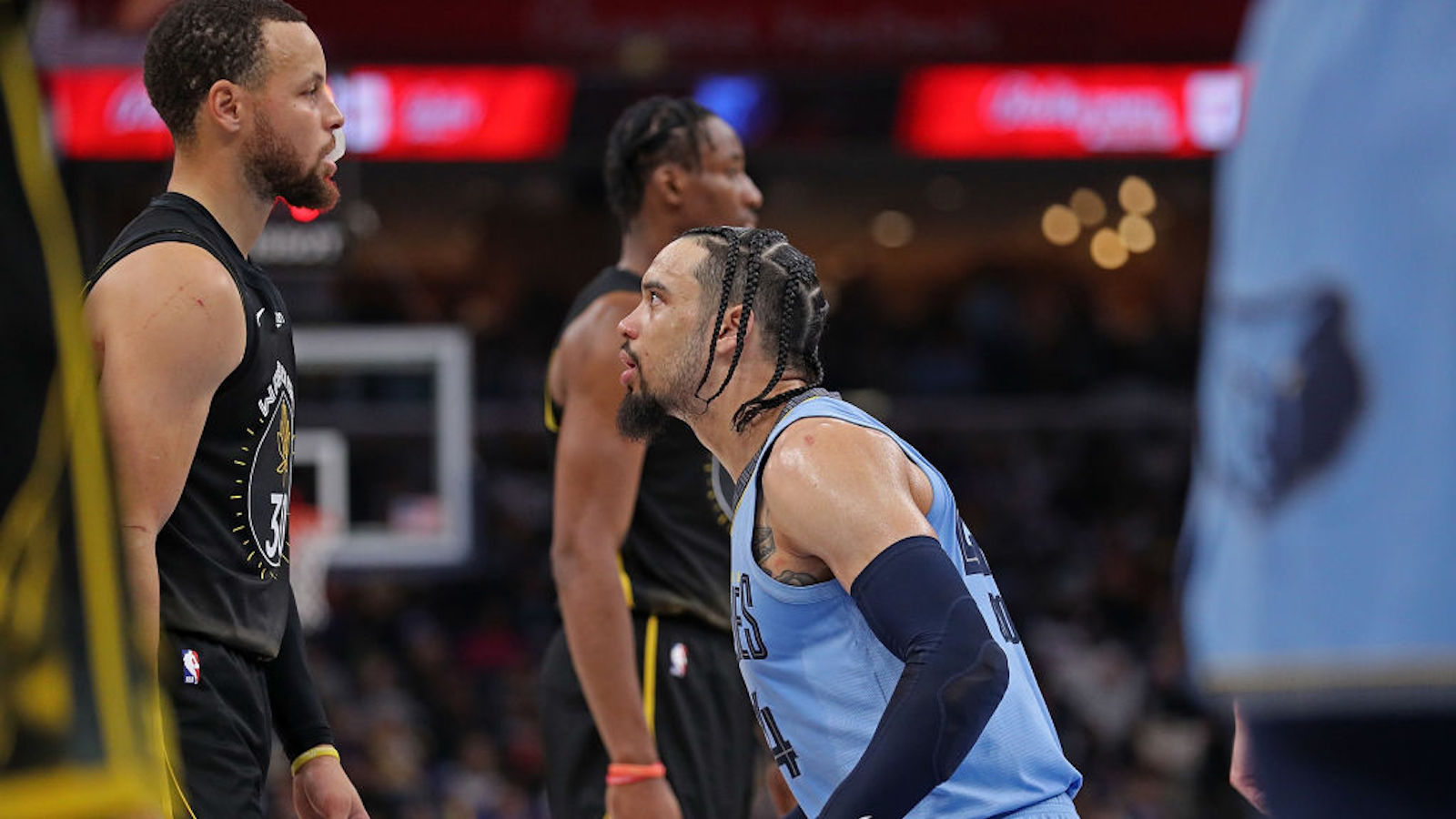 MEMPHIS, TENNESSEE - MARCH 18: Dillon Brooks #24 of the Memphis Grizzlies looks at Stephen Curry #30 of the Golden State Warriors during the first half of the game at FedExForum on March 18, 2023 in Memphis, Tennessee. NOTE TO USER: User expressly acknowledges and agrees that, by downloading and or using this photograph, User is consenting to the terms and conditions of the Getty Images License Agreement.