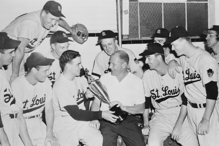 (Original Caption) Players Present Trophy to Veeck. Boston, Massachusetts: Rough Rodger Hornsby was fired June 10 as manager of the St. Louis Browns, and club president Bill Veeck (center) personally apologized to the players for hiring the grizzled old "Rajah" in the first place. The players immediately whipped out a silver trophy which they had bought on a rush-order basis. Here, pitcher Ned Garver (second from left) presents the trophy to Veeck. Trophy was engraved, "For the Greatest Play since the Emancipation Proclamation." Veeck named mild-mannered Marty Marion as the team's new pilot. June 10, 1952.