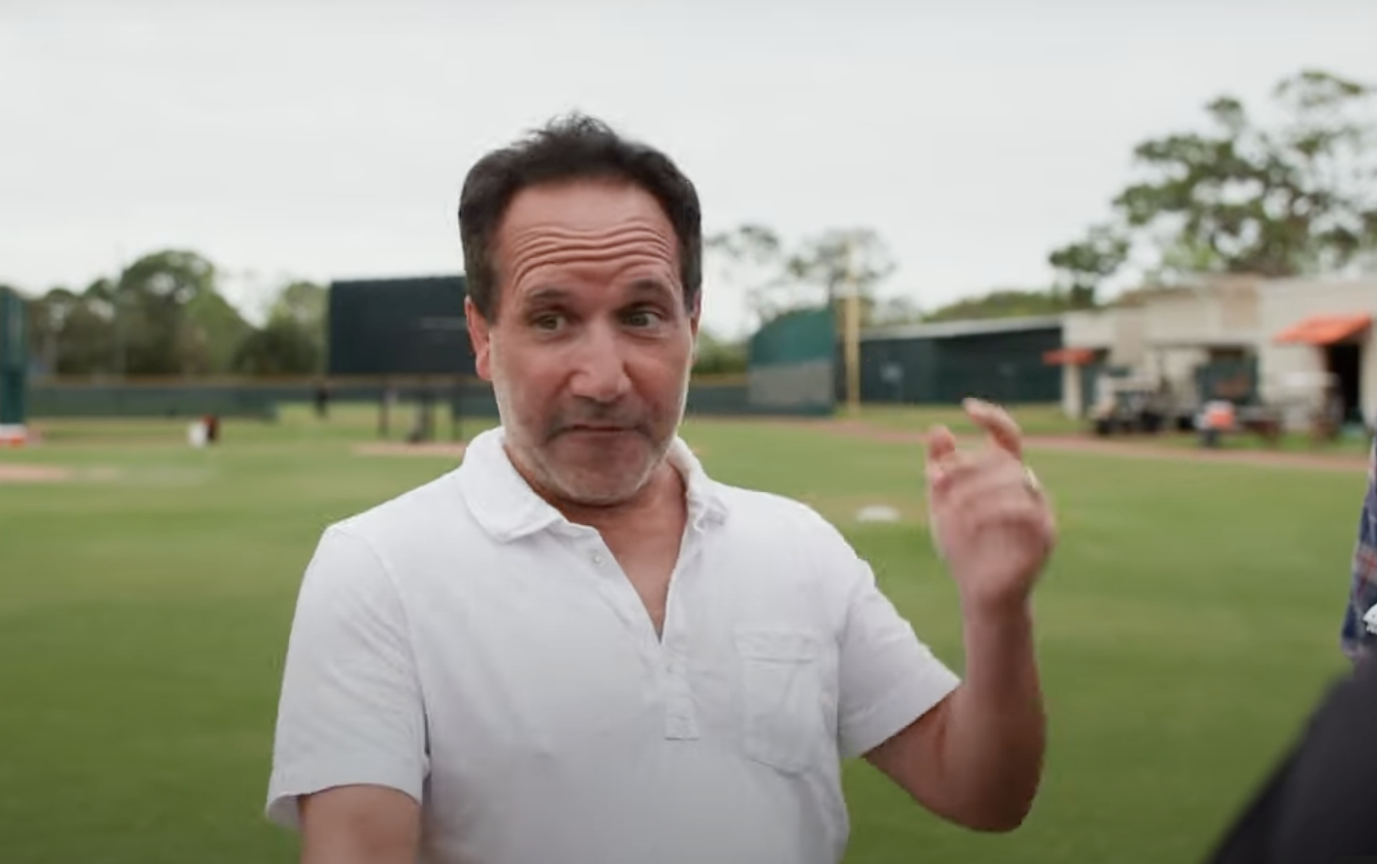 John Angelos speaks to press during spring training.