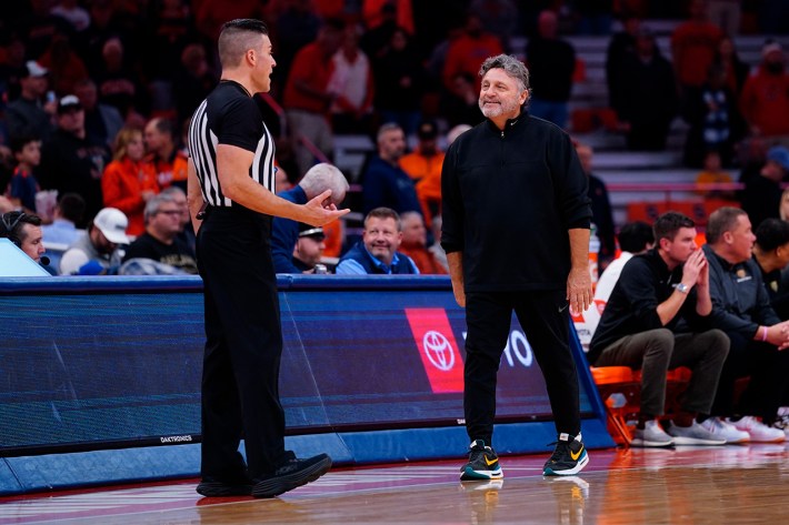 SYRACUSE, NY - DECEMBER 06: Oakland Golden Grizzlies Head Coach Greg Kampe speaks with an official during the first half of the college basketball game between the Oakland Golden Grizzlies and the Syracuse Orange on December 6, 2022, at the JMA Wireless Dome in Syracuse, NY.