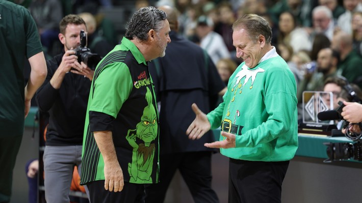 EAST LANSING, MI - DECEMBER 21: Head coach Tom Izzo of the Michigan State Spartans (R) talks with head coach Greg Kampe of the Oakland Golden Grizzlies before the game at Breslin Center on December 21, 2022 in East Lansing, Michigan.