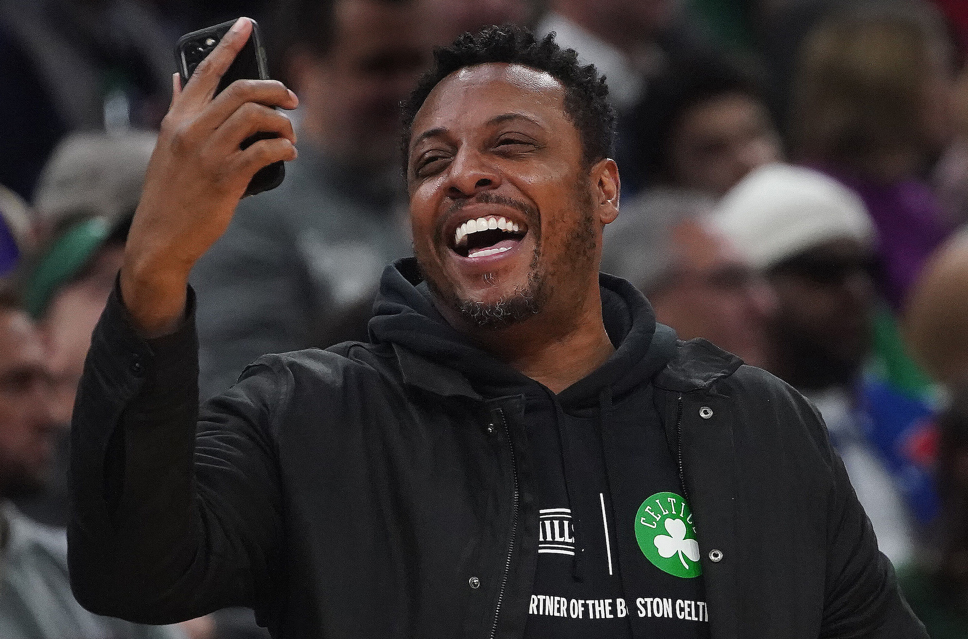 Paul Pierce looks at his phone during a Celtics game